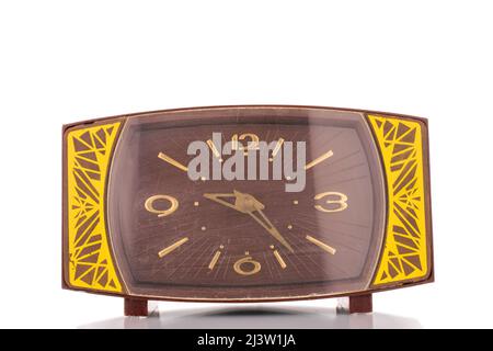 One old mechanical alarm clock, close-up, isolated on a white background. Stock Photo