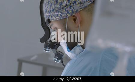 Doctors . Action. Two surgeons performing the operation in the hospital with all the equipment. Stock Photo