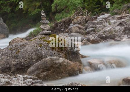 stone tower on a rock in the torrent Stock Photo