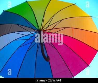 Isolated opened umbrella in rainbow colours Stock Photo