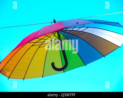 Isolated opened umbrella in rainbow colours Stock Photo