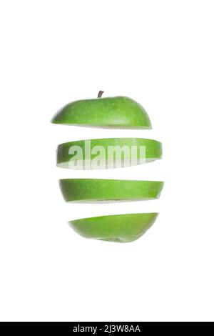 Floating green apple slices isolated on a white background Stock Photo