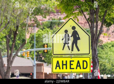 Crosswalk Sign Against green trees in small american town Stock Photo