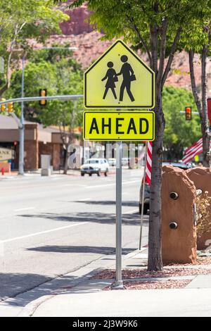 Crosswalk Sign Against green trees in small american town Stock Photo