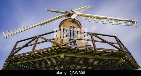 Volunteers clean woodwork at Wilton windmill, Wiltshire, where members of the Wilton Windmill Society are helping to complete the annual Spring clean of the traditional tower mill with fantail, built in 1871 and operational for 100 years. Picture date: Sunday April 10, 2022. Stock Photo