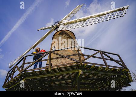 Volunteers clean woodwork at Wilton windmill, Wiltshire, where members of the Wilton Windmill Society are helping to complete the annual Spring clean of the traditional tower mill with fantail, built in 1871 and operational for 100 years. Picture date: Sunday April 10, 2022. Stock Photo