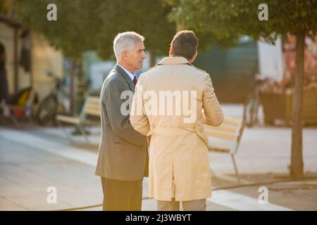 Two seniors businessmen are having a conversation, outside Stock Photo