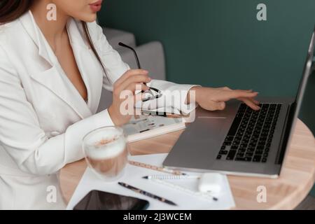Woman hands typing on laptop keyboard at the office, Woman worker and business concept. Stock Photo