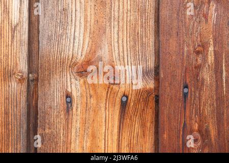 Wooden wall from old boards with knots and rusty nails, natural background vertical wood panel Stock Photo
