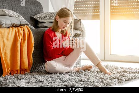 Preteen girl with smartphone Stock Photo