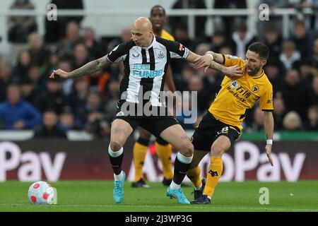 NEWCASTLE UPON TYNE, APR 8TH Jonjo Shelvey of Newcastle United in action with Wolverhampton Wanderers' Joao Moutinho during the Premier League match between Newcastle United and Wolverhampton Wanderers at St. James's Park, Newcastle on Friday 8th April 2022. (Credit: Mark Fletcher | MI News) Credit: MI News & Sport /Alamy Live News Stock Photo