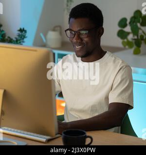 Happy successful programmer enjoy working from home on remote or freelance website or app project Stock Photo