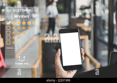 Customer service and Satisfaction concept ,Women hand hold smart phone empty screen choose the 5 star icon to give satisfaction in service. rating ver Stock Photo