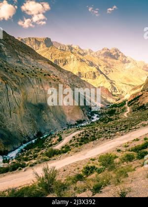 Scenic mountain road to Iskanderkul - an alpine lake in the mountains of Tajikistan Stock Photo