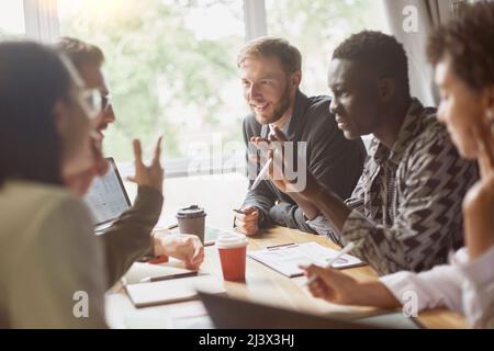 young entrepreneurs discussing a joint project in the office of the coworking center. Stock Photo