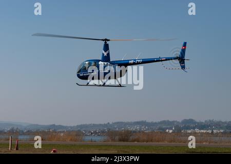 Wangen-Lachen, Switzerland, March 27, 2022 Robinson R44 Raven II helicopter arrival on a small airfield Stock Photo