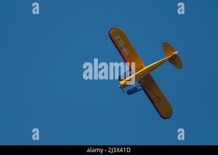 Wangen-Lachen, Switzerland, March 27, 2022 Piper PA18-180M Super Cub propeller plane in the blue sky Stock Photo