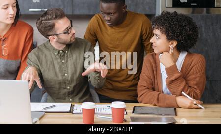 business man explaining something to his colleagues . Stock Photo