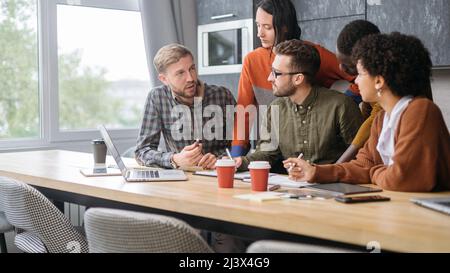 project manager is explaining something to young employees . Stock Photo