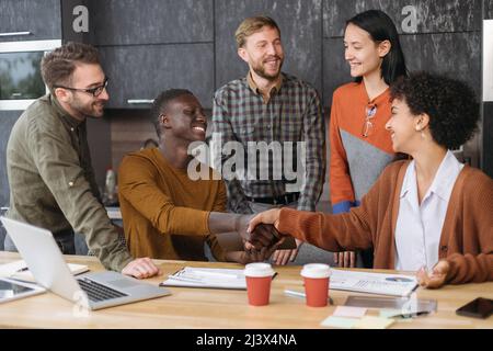 colleagues using a digital tablet during a work meeting . Stock Photo