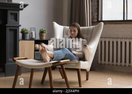 Focused freelance woman in casual working on online project Stock Photo