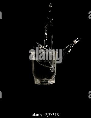 Glass with water drops on a black background Stock Photo