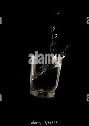 Glass with water drops on a black background Stock Photo