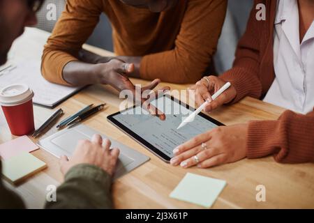 business team with a digital tablet works discussing financial data. close-up. Stock Photo
