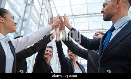 Happy successful business team giving a high fives gesture as th Stock ...