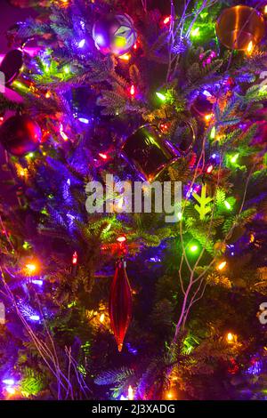 Close up of a christmas tree with colourful fairy lights Stock Photo