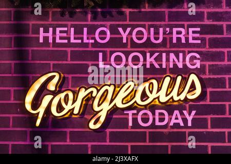 empowering slogan written on a brick wall Stock Photo