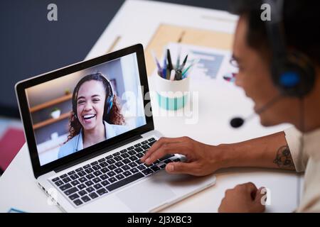 Close up of video screen with a conference call between two young people at work Stock Photo