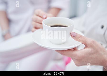Focused photo on female hand holding cup Stock Photo