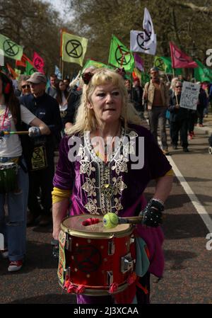 London, UK. 09th Apr, 2022. An Extinction Rebellion drummer joins the march through central London against climate change and fossil fuels.  10th April 2022. Anna Hatfield/ Pathos Credit: Pathos Images/Alamy Live News Stock Photo
