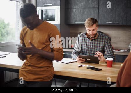 young man using a digital tablet in a coworking center. Stock Photo