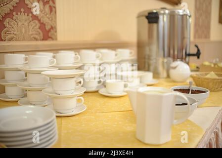 A set of dishes for buffet. Cups, saucers and plates. Stock Photo