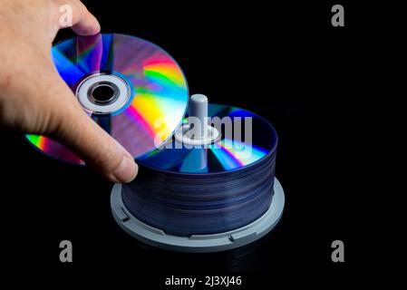 Hand holding a blank CD or DVD disc Stock Photo