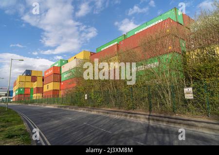 An international shipping company stacks their shipping container in the port of Felixstowe which is the largest and busiest container port in the UK. Stock Photo