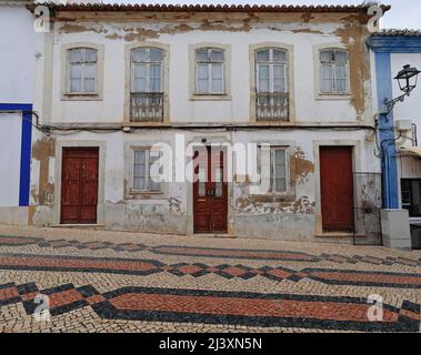 Paint faded façade-closed wooden doors-windows-balconets of old Neoclassical townhouse. Lagos-Portugal-210 Stock Photo