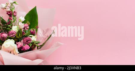 bouquet of dying flowers on pink background, dead flowers Stock Photo