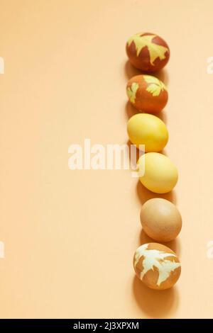 Easter eggs dyed with natural dyes, onion peel, turmeric, beetroot on a light background. Stock Photo
