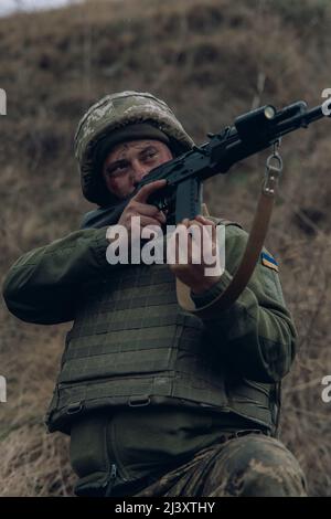 Portrait of a Ukrainian military man with a Kalashnikov assault rifle ...