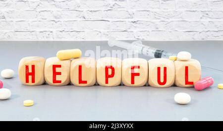 Top view of crossword with words helpful tips. Alphabet blocks with letters on the wooden board Stock Photo