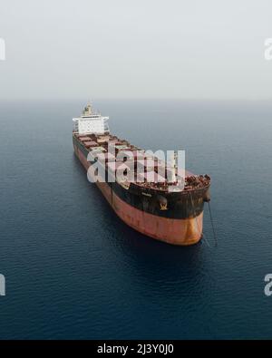 Anchored ship on a calm misty sea