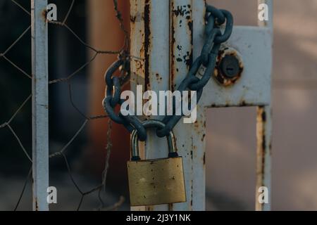 old padlock on a mold padlock on a metal fence etal fence. High quality photo Stock Photo