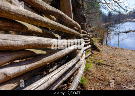 Wicker rustic wooden fence made of aspen and willow sticks. Close-up. Texture, background. Organic woven willow wicker fence panel suitable for crafts Stock Photo