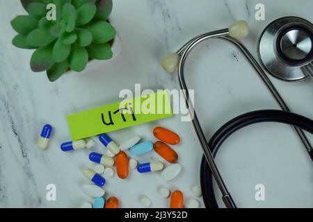 UTI write on sticky notes isolated on Wooden Table. Stock Photo
