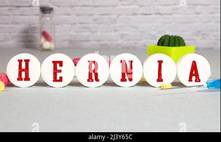 The word HERNIA, spelt with wooden letter tiles over a white background Stock Photo