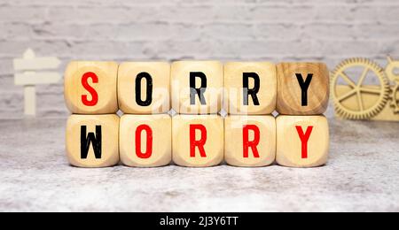 Sorry to worry. Hand turns a dice and changes the word worry to sorry Stock Photo