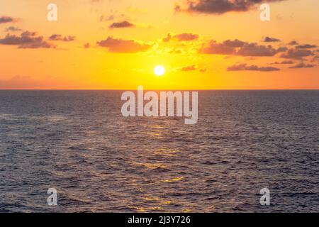 Sun setting over sea from Marella Explorer 2 cruise ship, Caribbean Sea, Caribbean Stock Photo